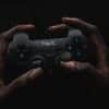 person holding black Havit game controller