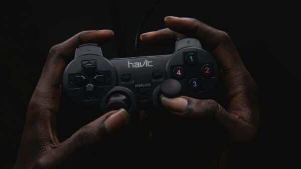 person holding black Havit game controller