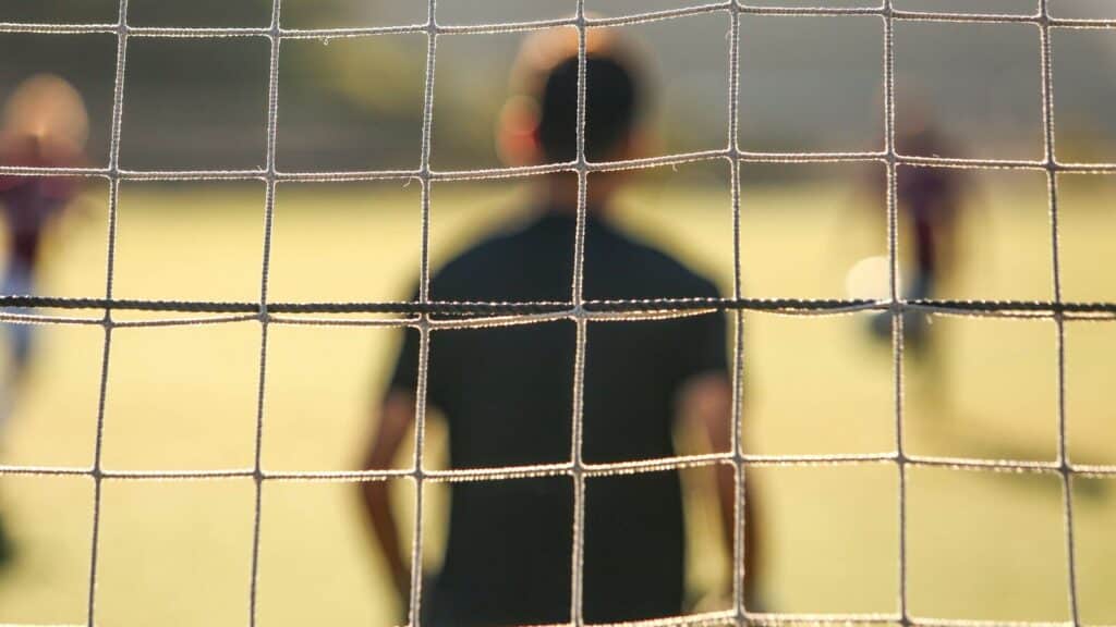 man standing near the goal post