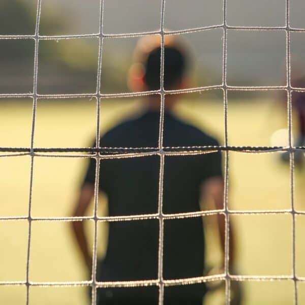 man standing near the goal post