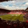 A stadium filled with lots of people watching a soccer game