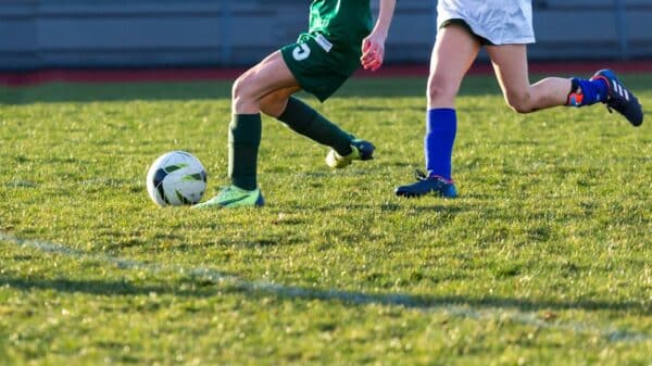 a couple of kids playing a game of soccer
