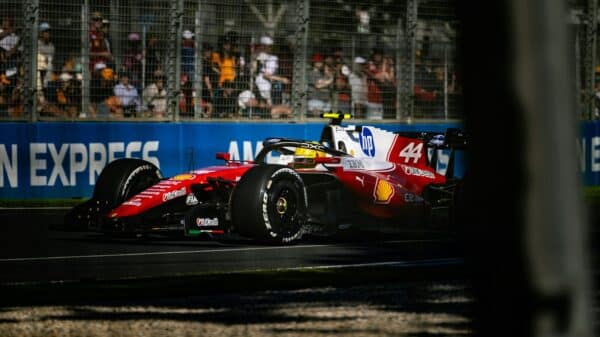 A red and white race car speeds around a track