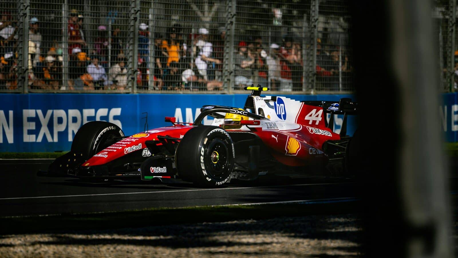 A red and white race car speeds around a track