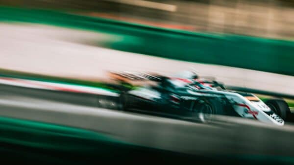 a blurry photo of a racing car driving down a track