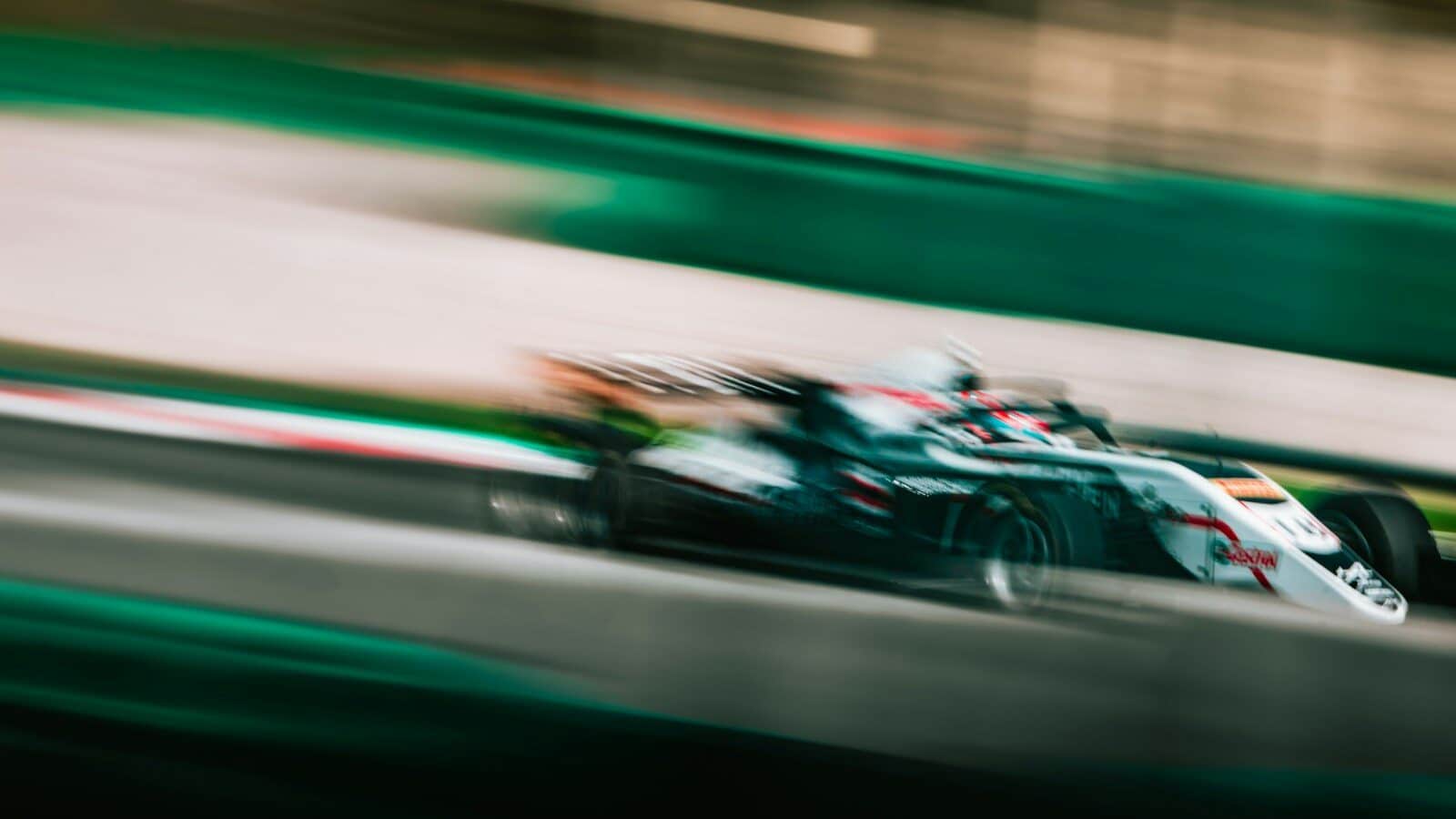 a blurry photo of a racing car driving down a track